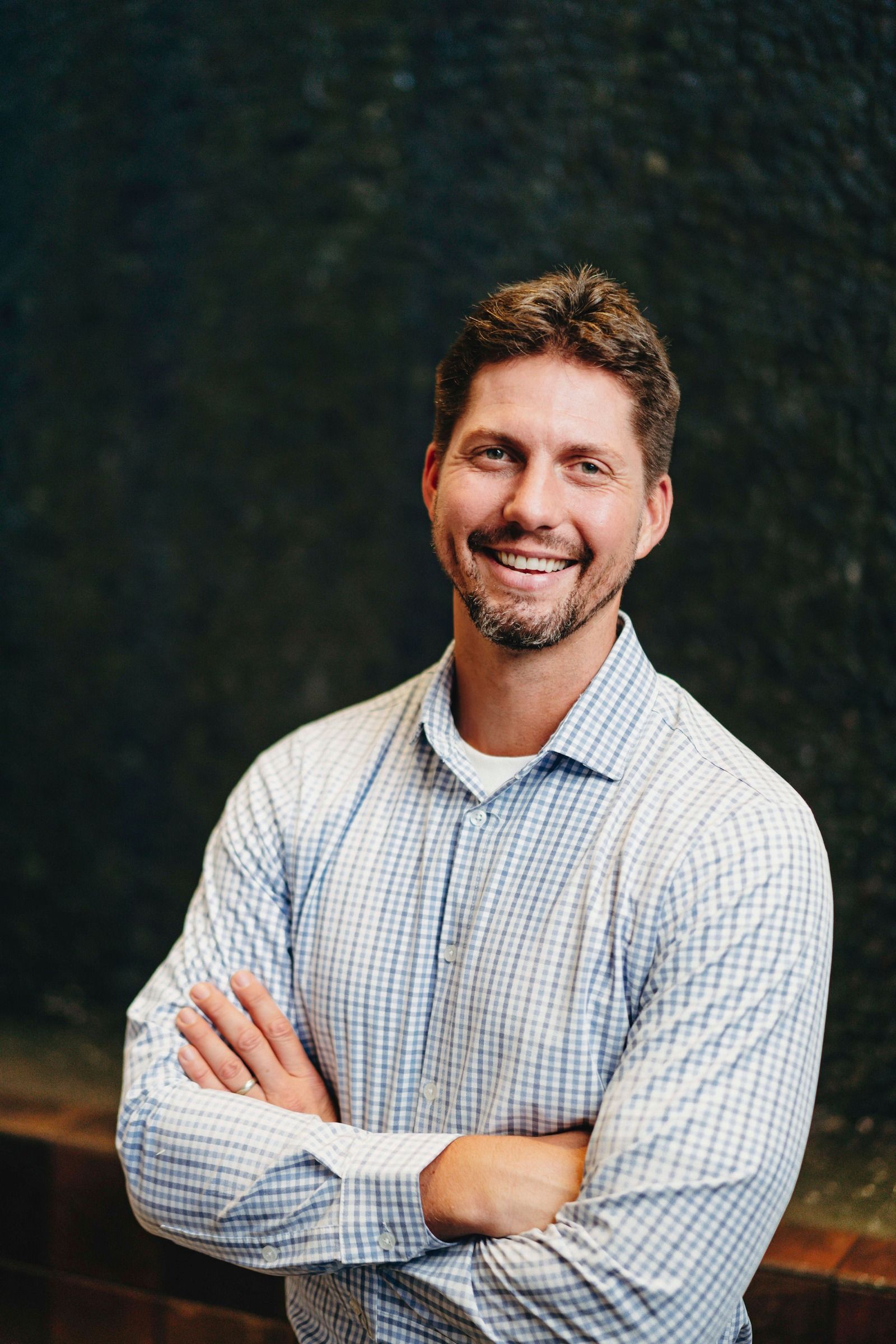 Tyler Moberg smiling in a relaxed professional portrait.